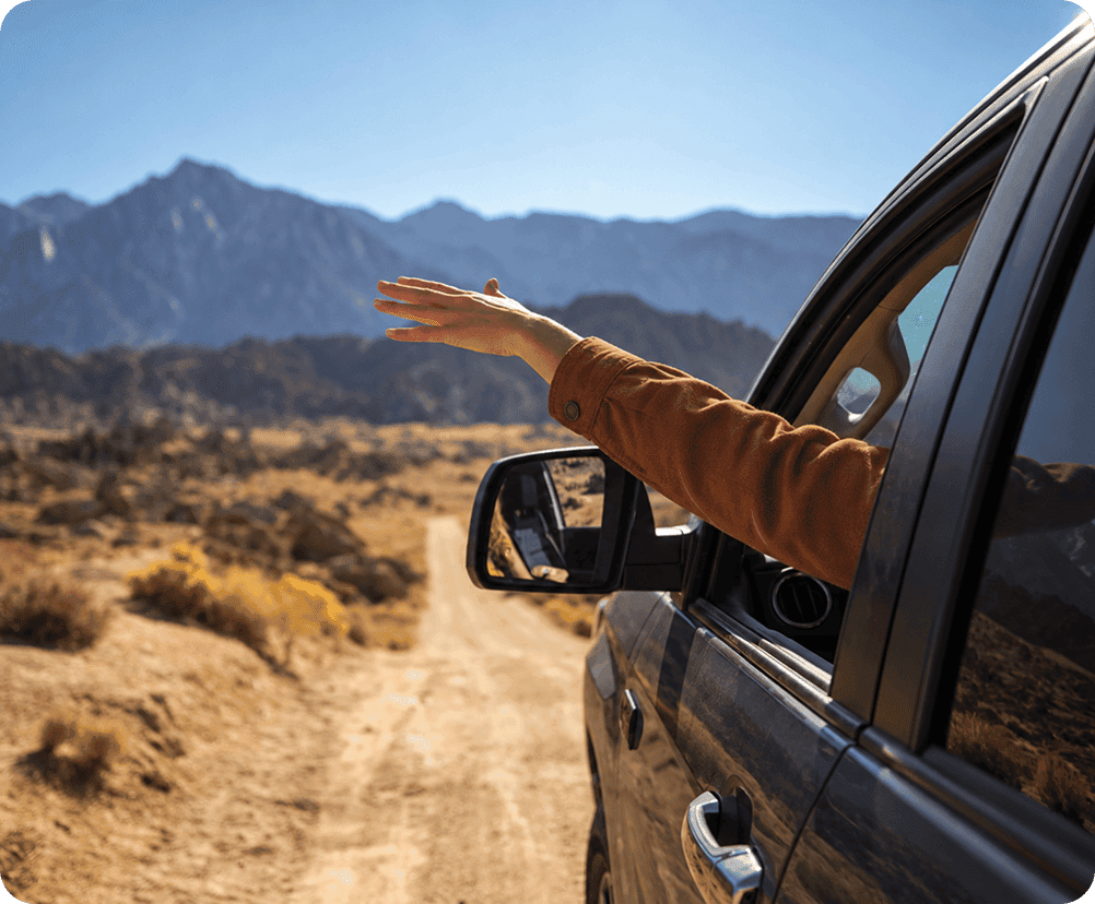 hand outside the passenger seat window of car