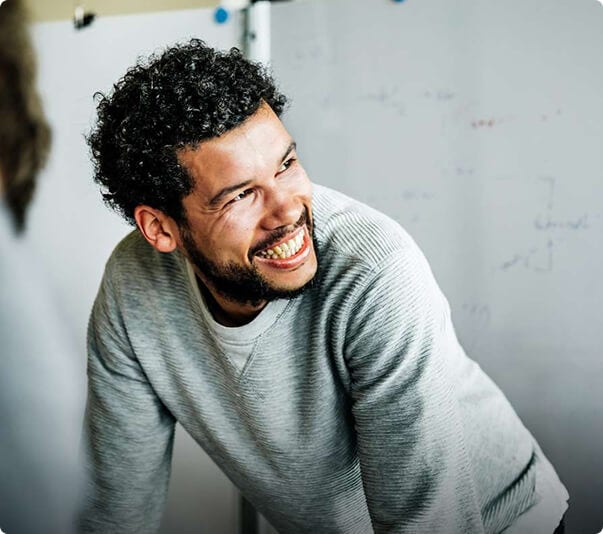 Man in gray shirt smiling